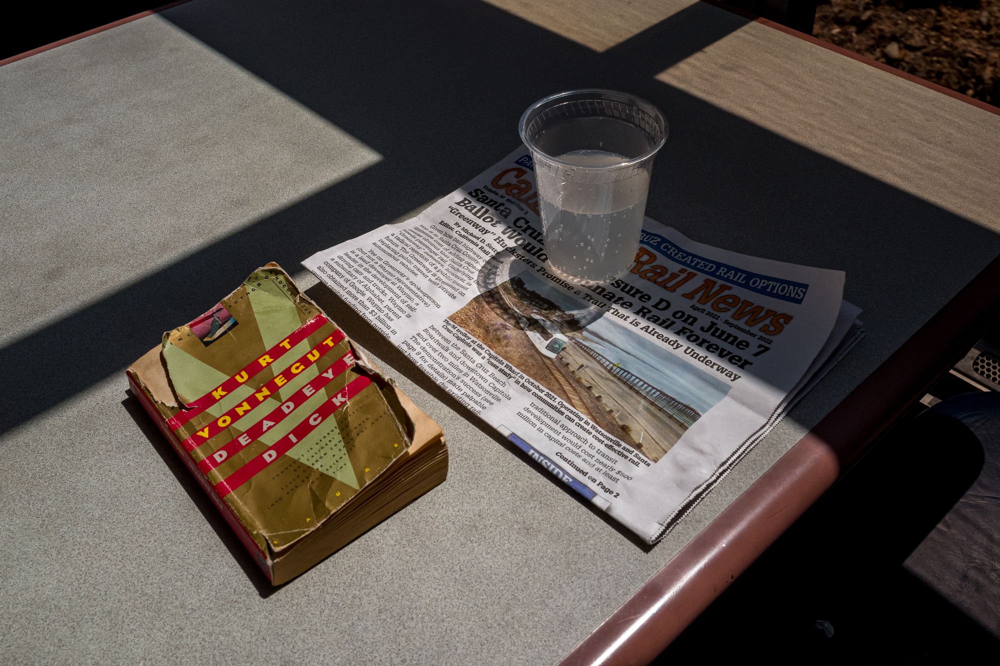 Amtrak passenger book, newspaper, and soda